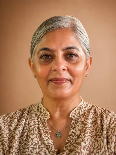 Neena, NeenaVeda face yoga coach, smiling warmly